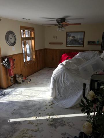 <p>This homeowner's possessions are covered with plastic and moved away from the walls.</p>