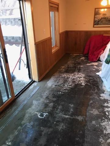 We do not cement over the trench drain in case water does come in from these sliding glass doors, the system will catch it before damage can occur