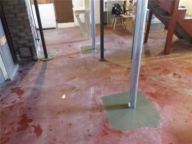 Concrete footing blends into the basements existing floor