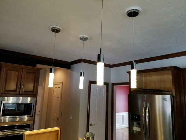 Additional pendant lighting give this modern kitchen the light needed to see as well as elegance.