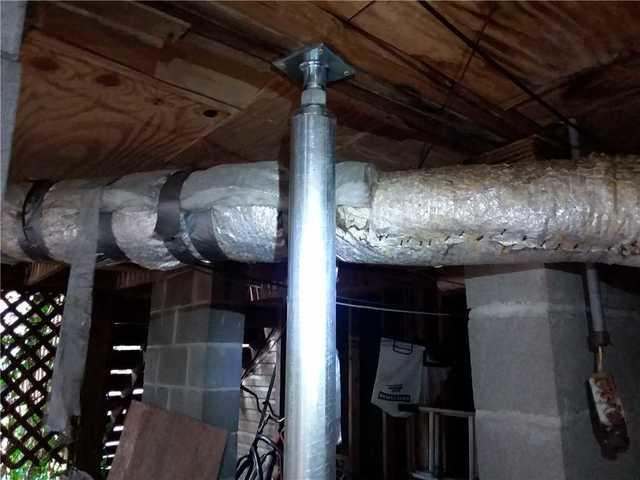 He suggested lifting the foundation with SmartJacks. A SmartJack is a galvanized steel column support that lifts sagging floor joists.