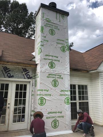 Here we are installing new flashing at the base of the chimney. So that wind driven rain won't be able to get into the house and cause anymore damage.