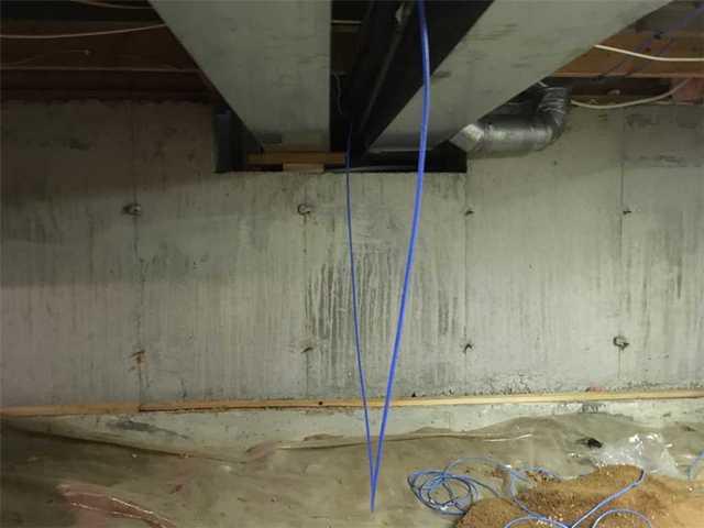 This is a before photo of the crawl space before transformation.  Dirt still exposed and a clear plastic liner not sealed properly inside the crawl space.