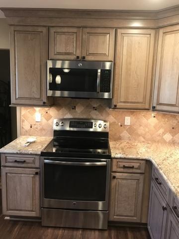 Close-up view of the microwave and electric convection oven.