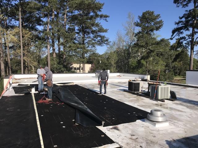 Saturated roof membrane being torn off.