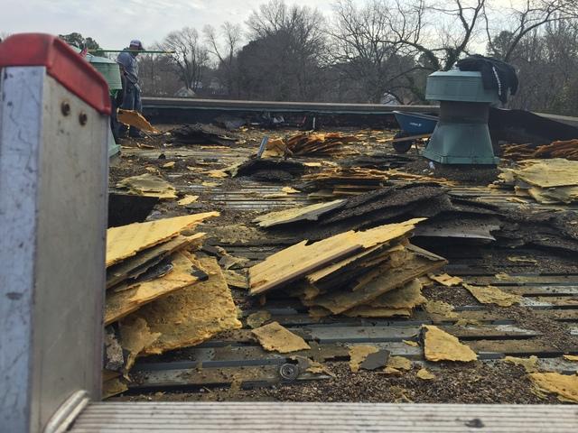 Our team hard at work removing the old roofing.