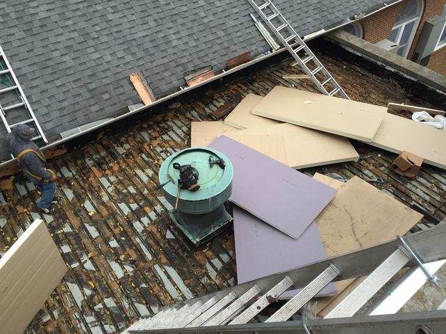 Our team preparing to install insulation on this commercial roof.