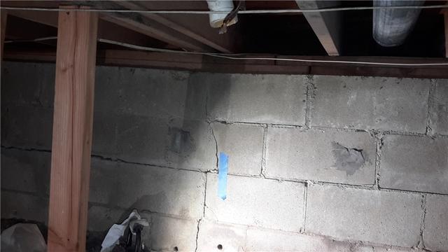 The cracks in the basement wall, prior to any solutions applied by Quality 1st.