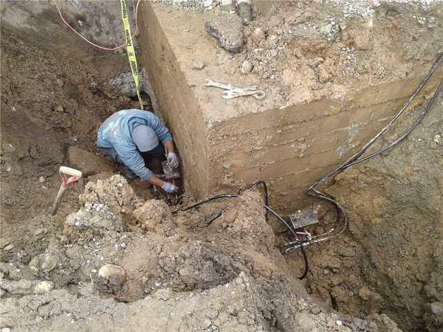 An exterior shot of our team installing the Helical Piers.