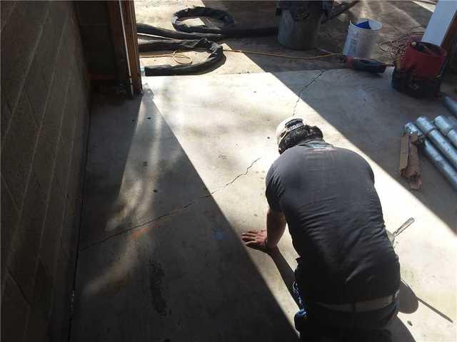 Our team inspecting the crack in the foundation.