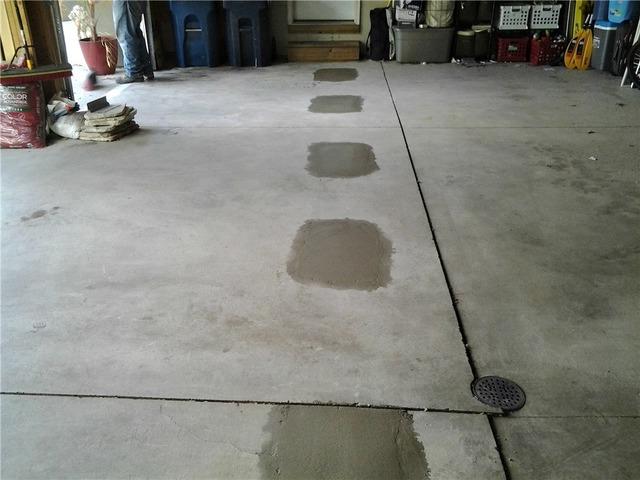 They have replaced the concrete that was removed in the garage in order for them to install the anchors.