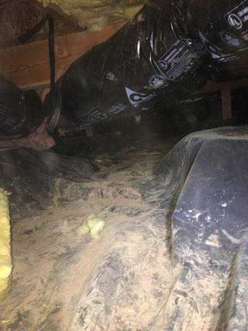 This crawlspace was lined with a black plastic vapor barrier and was allowing water in and insulation was falling.