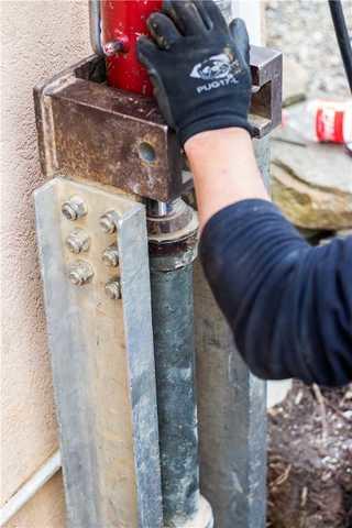 Installing the Steel Piers to Stabilize Home