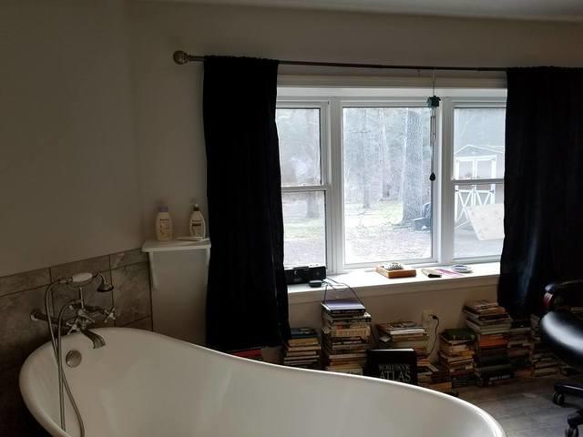 There is also a relaxing free stand jetted tub looking outside into nature.