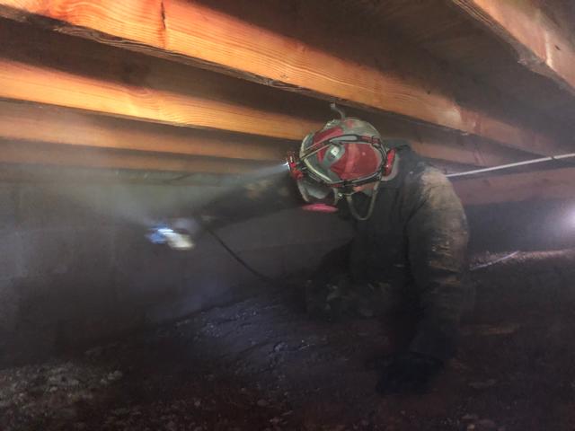 In this photo, you can see the mold remediation has begun. The mold removal team is drawing air out of the crawl space and filtering it, while scrubbing down the subfloor.