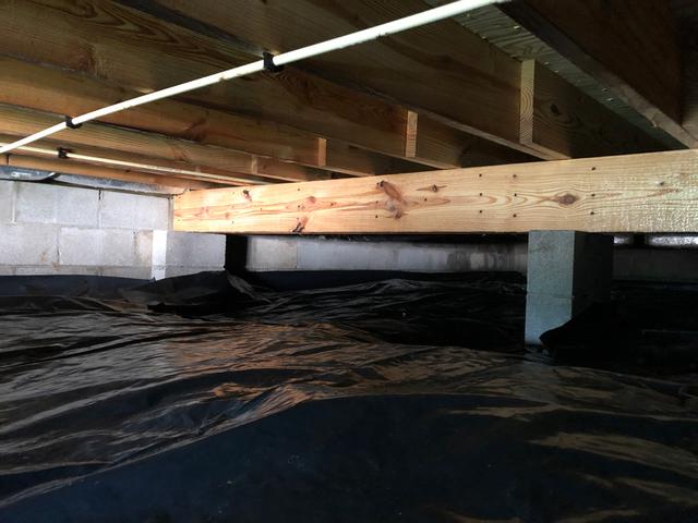 In this picture, you can see that the mold remediation equipment has been removed and the Healthy Spaces crawl space team has installed a liner to stop water vapor from rising into the house.