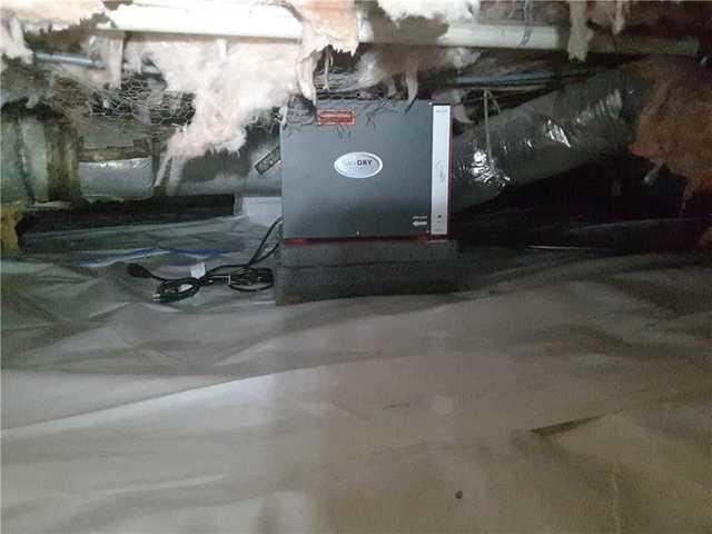 Lowcountry Foundation Repair encapsulated the crawl space to reduce moisture and remove humidity from the crawl space. Pictured is an Energy Star Rated SaniDry Sedona dehumidifier in Tony's crawl space.