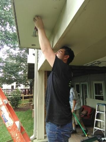 A Production crew member dense packing the cantilever