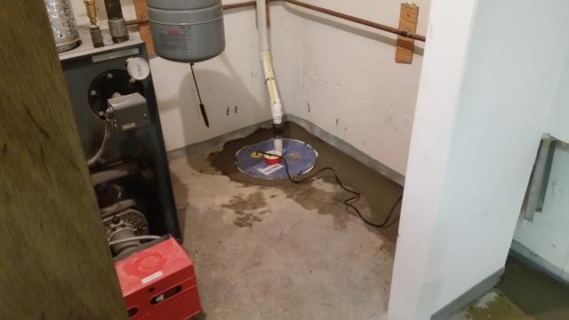 Photo of the SuperSump pump system we installed in the lowest point of the basement.