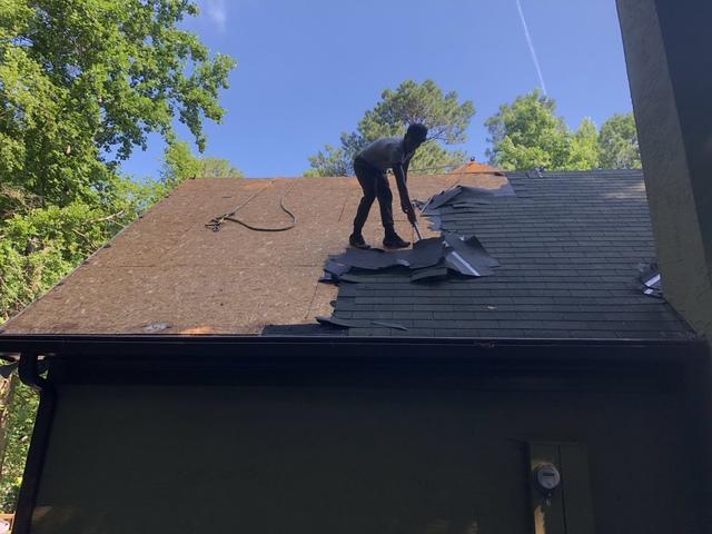 Tearing off the old three tab shingle and getting down to the OSB plywood to make sure there wasn't any rotten wood.