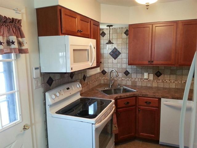 Newly done counter top, hardwood cabinets, and tiled walling