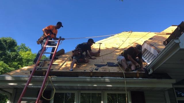 The crew works to remove the existing shingles. After removing the existing shingles, our crew will install brand new asphalt shingles for this customer's roof replacement.