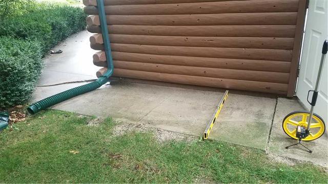 This walkway to the garage has a very unlevel slab on it. This is bad for a few reasons. 1. It can cause someone to trip and hurt themselves. 2. It looks terrible. 3. If the concrete is sagging towards your house it is directing any precipitation directly towards your home and into your basement (we all know how that ends.). The giant crack on the left and the unlevel slab on the right can be easily fixed within 15 minutes with PolyLevel.