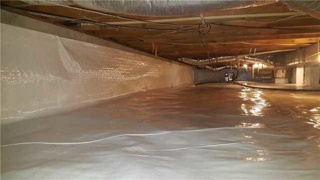 WOW! This crawl space looks and FEELS like new in Georgetown, DE. What you can't see is even more important than what you can see. The effective waterproofing done below the clean space liner and the dehumidifier in the distance are doing the hard work to protect this home.