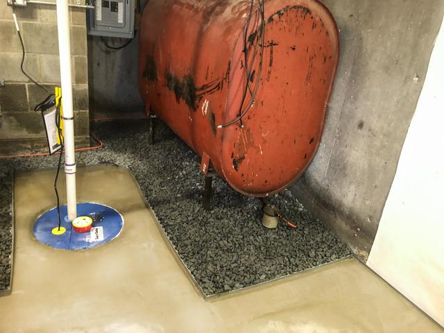 The SuperSump is installed and already hard at work pumping out water.  The WaterGuard System will bring the water entering the basement to it and then pump it out the discharge line away from the house.