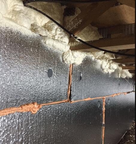 Another shot of our SilverGlo Wall Panels along with some Spray Foam Insulation that has sealed the area where the floor meets the panels. This foam will not allow any air to escape through the cracks.