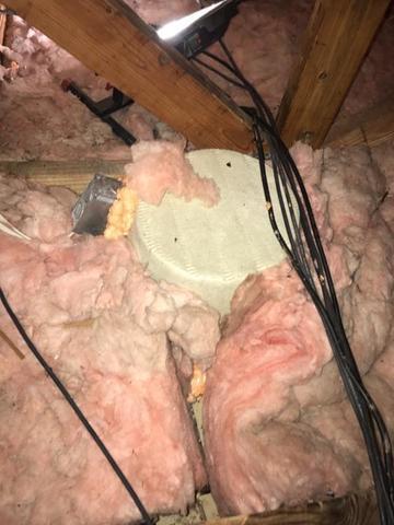 This brown circle covers a recess light that is not allowed to be in contact with any insulation.(Per Code) The cover seals any air from leaking through and allows the area to be buried under the new cellulose insulation.