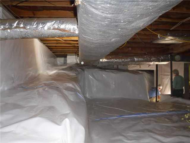 Here is a another view of the CleanSpace that our crew installed in this home. For only being a partial crawlspace, this was actually quite a large area. In this photo, the homeowner can be seen talking to one of our crew members, and shown exactly what they were doing and how the system was installed.