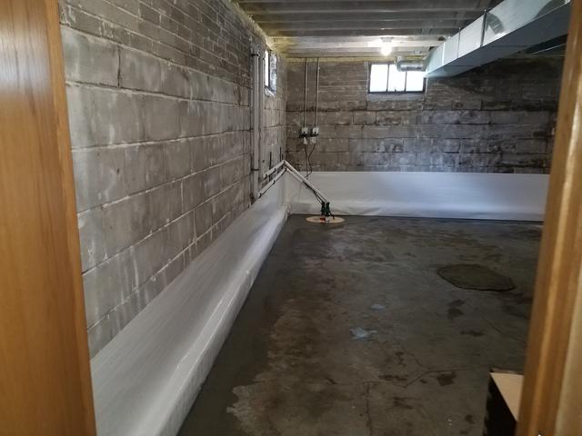 The full room view of the new sump pump and the cleanspace walls.