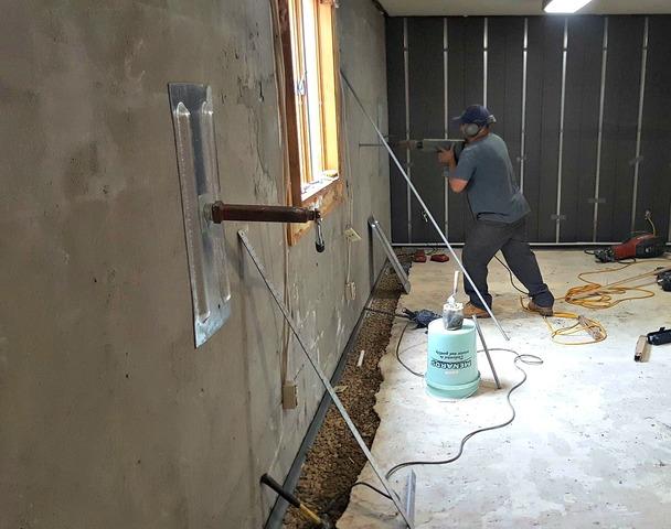 Our crew installed 9 wall anchors to permanently secure and stabilize Matt's foundation walls. Also, the drainage system has been installed and the gaps in the trench have been filled back with rock.