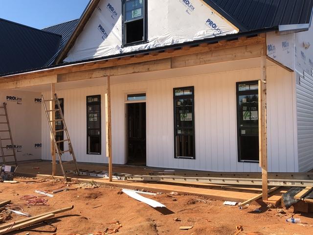 New Vinyl Board and Baton Vertical Siding being Installed