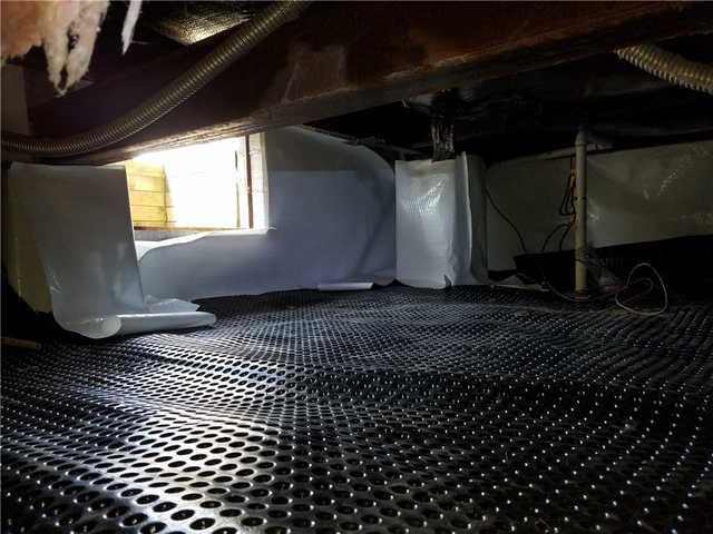 Once the drainage matting is in place, we can begin installation of the CleanSpace vapor barrier. CleanSpace is attached to the walls and floor to protect the crawl space from all sources of incoming water.