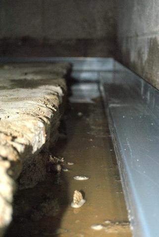 <p>Here's a photo of what the WaterGuard looks like sitting right down in the trench the crew had opened up. Once it's all finished, any water that comes in will drain straight to the sump pump.</p>