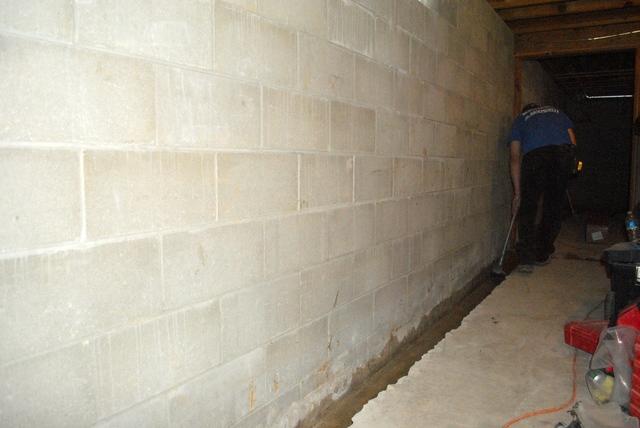 <p>The crew prepares to lay the WaterGuard down after jackhamming and cleaning the concrete pieces out.</p>