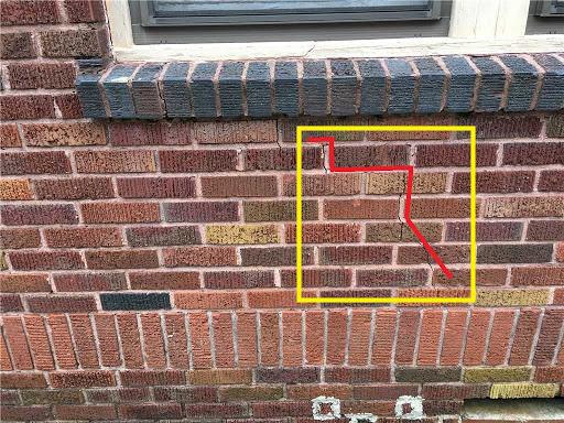 Sinking and settlement cracked the exterior brick wall