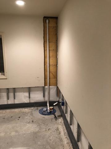 <p>Here you can see the discharge line that leads away from the sump pump sytem to the exterior of the home.</p>