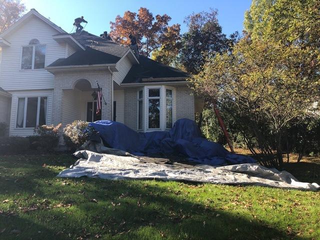 <p>My-Pros employees laid out tarps before tearing off the old roof.</p>