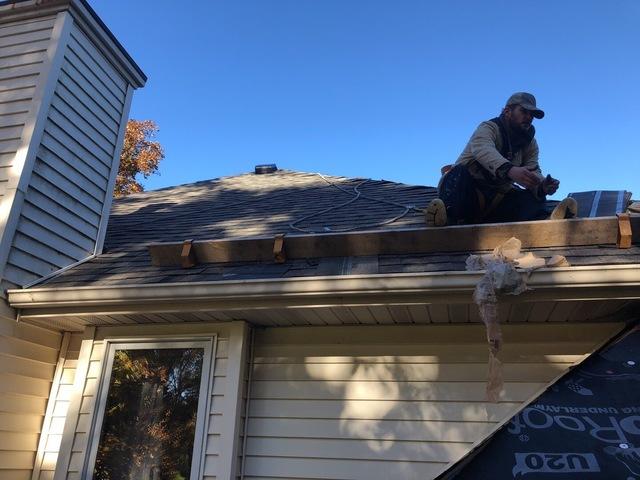 <p>Robbie is handing a co worker materials for the job while using the toe board to keep safe.</p>