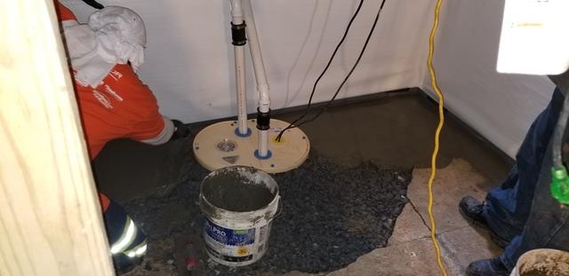 Sump pump installed by Travis and Larry