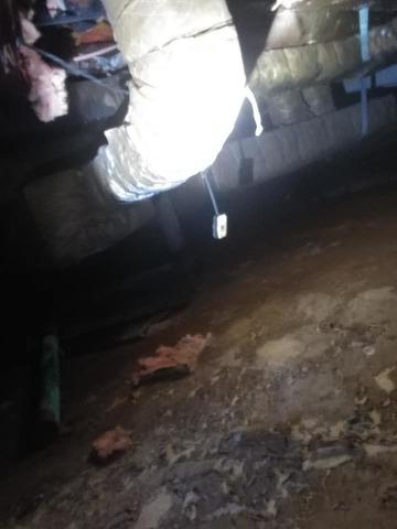 Corner of crawl space with insulation and electrical outlet