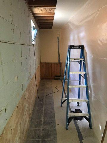 The crew partitioned the work area from the rest of the basement with sheet plastic to prevent dust and debris from entering other areas of the house.