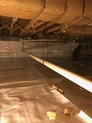 Another view of the discharge line from the sump pump.  Notice the line is secured and runs smoothly through the space allowing for thorough discharge outside.