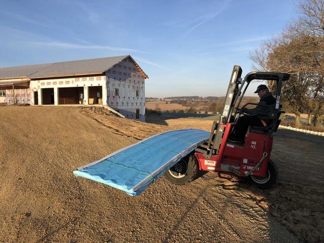 <p>The delivery operator is using a fork lift to drop off the metal. In the background you will see the scenery My-Pros employees really enjoyed while working.</p>
