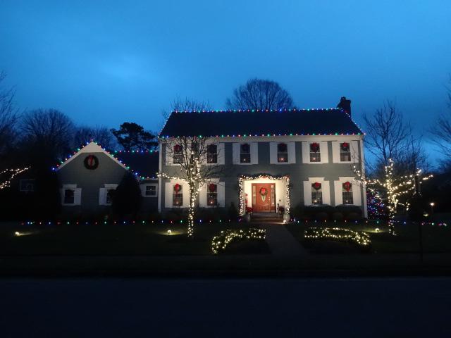 Multicolored ground stakes and roof lights make this Christmas display in Wall, NJ fun and festive