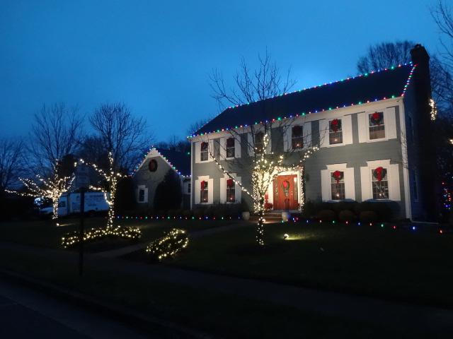 Multicolored ground stakes and roof lights make this Christmas display in Wall, NJ fun and festive