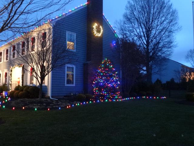 Multicolored ground stakes and roof lights make this Christmas display in Wall, NJ fun and festive